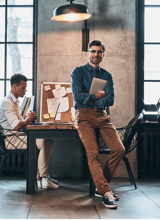 Man standing near desk discussing PEO services