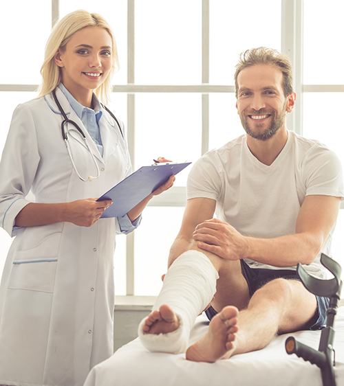 Doctor standing next to patient with a wrapped leg